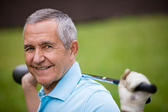Photo of a man with a golf club.